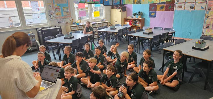 Children sitting listening to their teacher